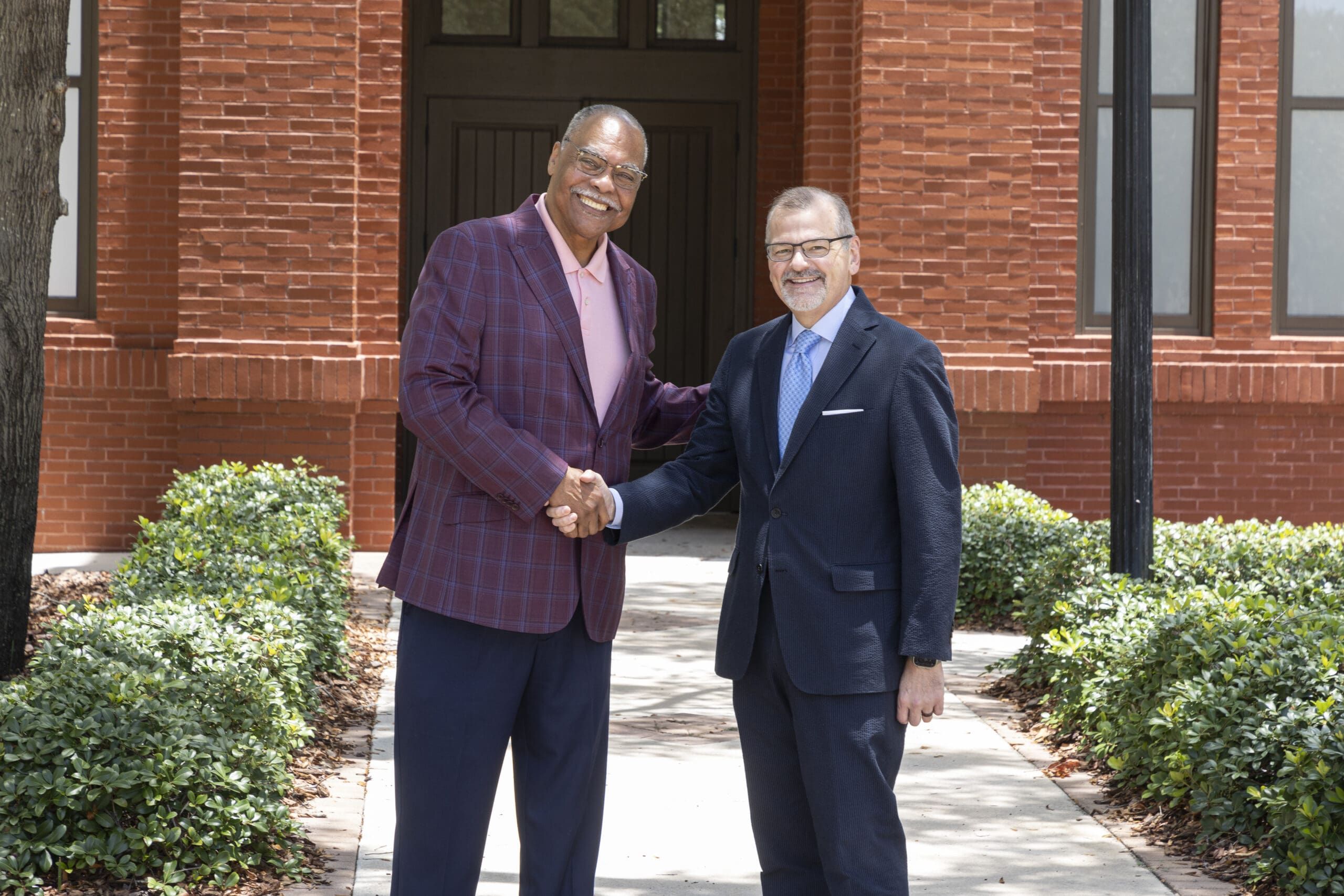 Jerome Ryans (left), President and CEO, Tampa Housing Authority, and C.J. Roberts, Frank E. Duckwall President and CEO of the Tampa Bay History Center greet each other in front of the future home of Tampa’s Black History Museum at Encore. The future museum’s new address is 1213 N. Central Ave. Tampa, Fla. (Photo by Kerrick Williams)