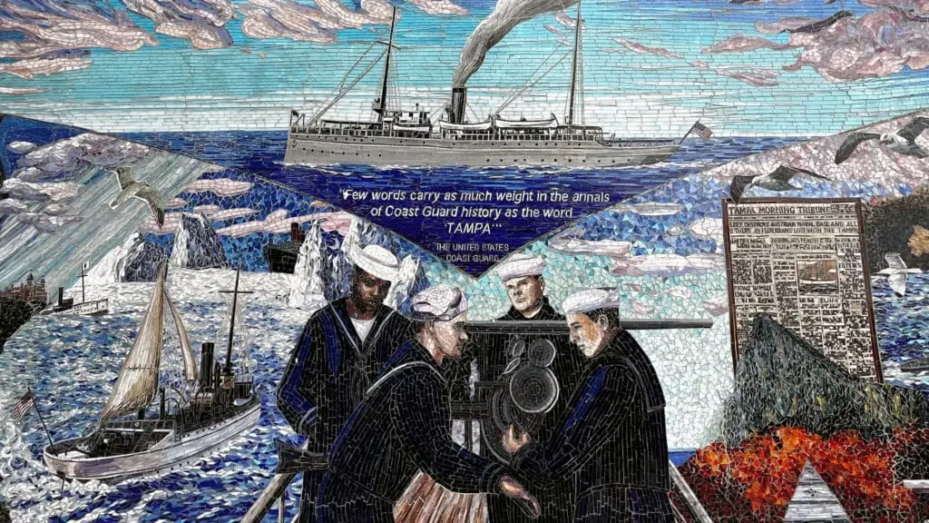 Close-up of the Cutter Tampa mosaic mural showing the ship, Coast Guard crew members, icebergs and a newspaper image.