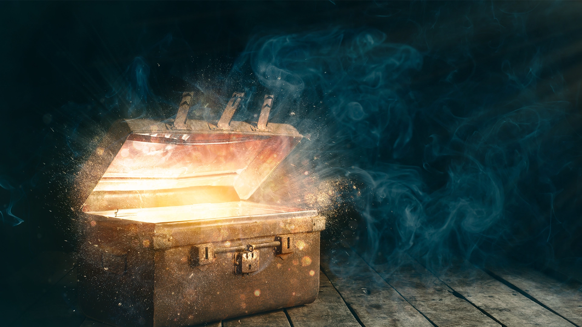 Open treasure chest glowing on a dark wooden floor with smoke and light shining from above